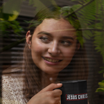 Load image into Gallery viewer, Powered by Jesus Christ - Black mug 11oz
